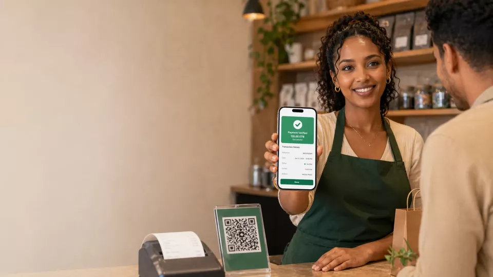 Ethiopian business owner confirming a customer payment with the Verify.ET mobile app at the counter